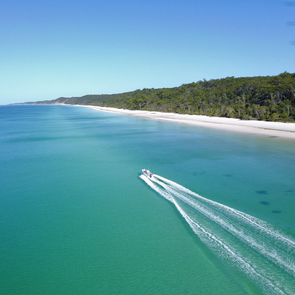 cruising up the coast of fraser island on a gotcha hire boat