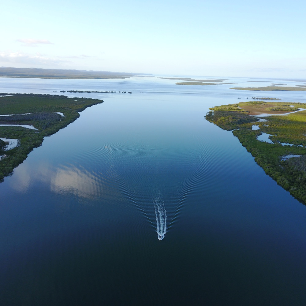 crusing down a river fraser island - aerial shot