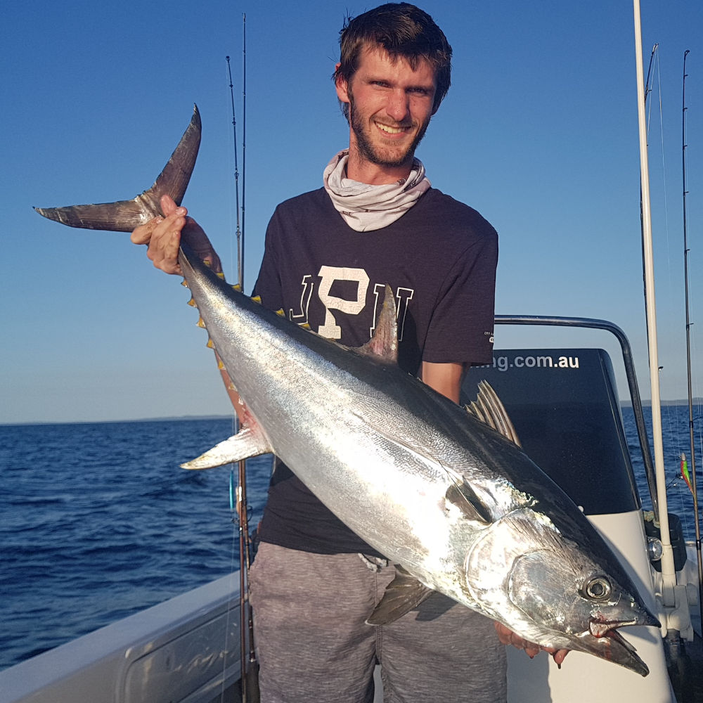 awesome catch - man holding large fish on a boat